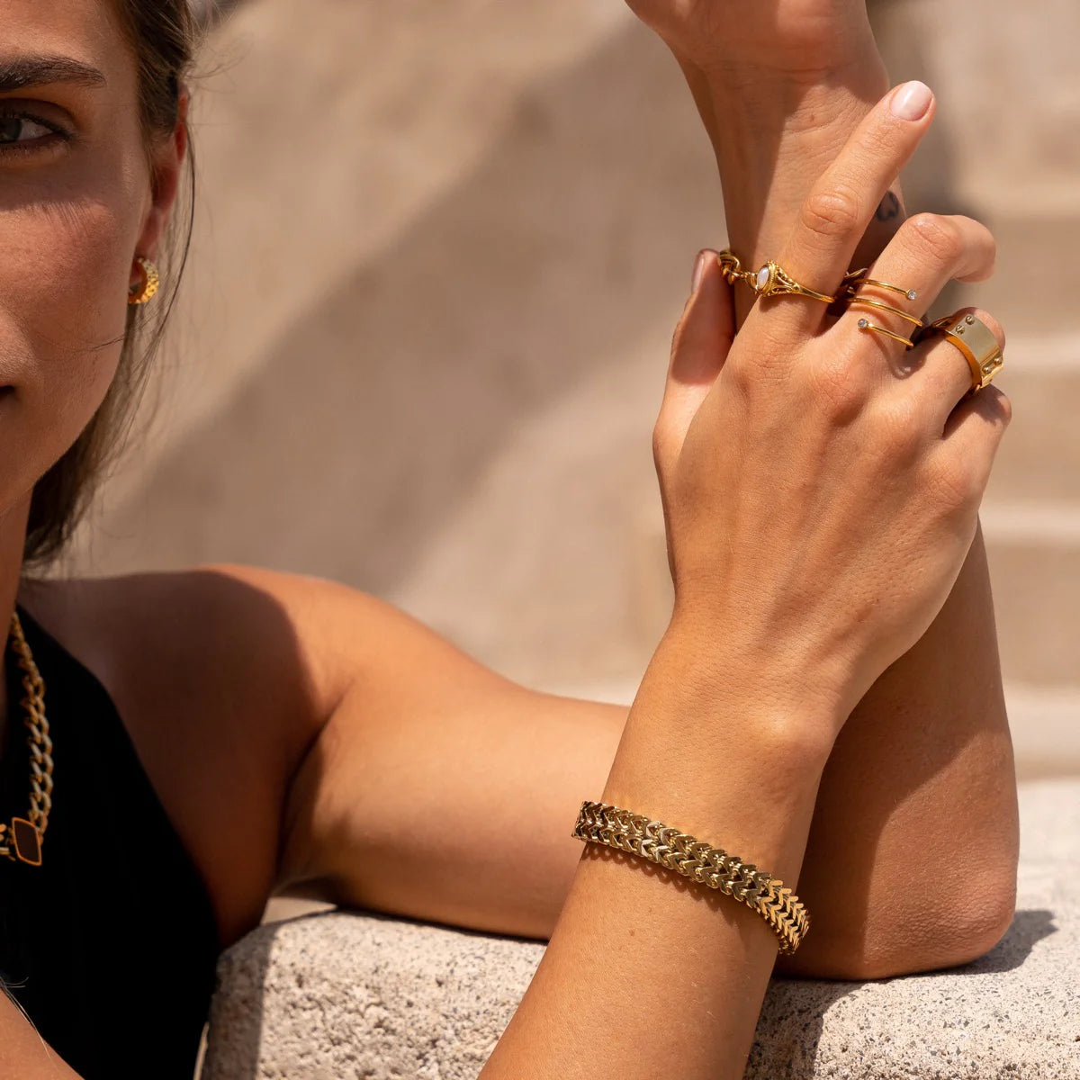 Eden Bracelet - Gold Tone Tone Textured worn with gold rings and necklace, perfect for accessorizing casual or formal outfits.