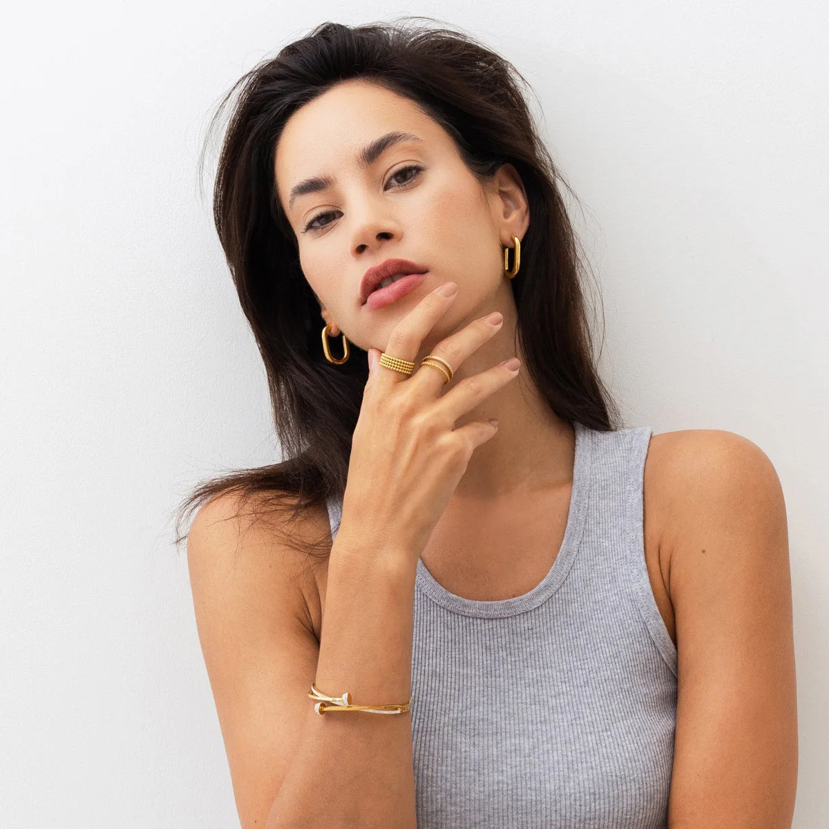 Gold Nail Bracelet - Edgy Glamour worn with matching gold jewelry. Bold, water-safe bracelet adds edgy elegance to any outfit.