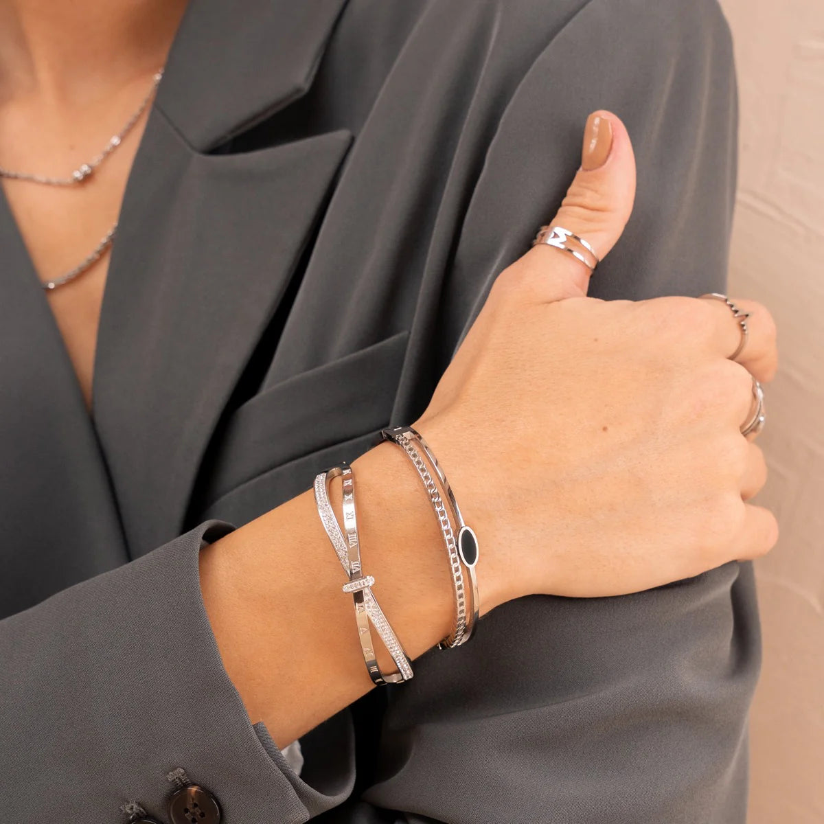 Riviera Bangle - Silver Tone Classic paired with other silver accessories, emphasizing its refined design and perfect fit for fashion-forward looks.