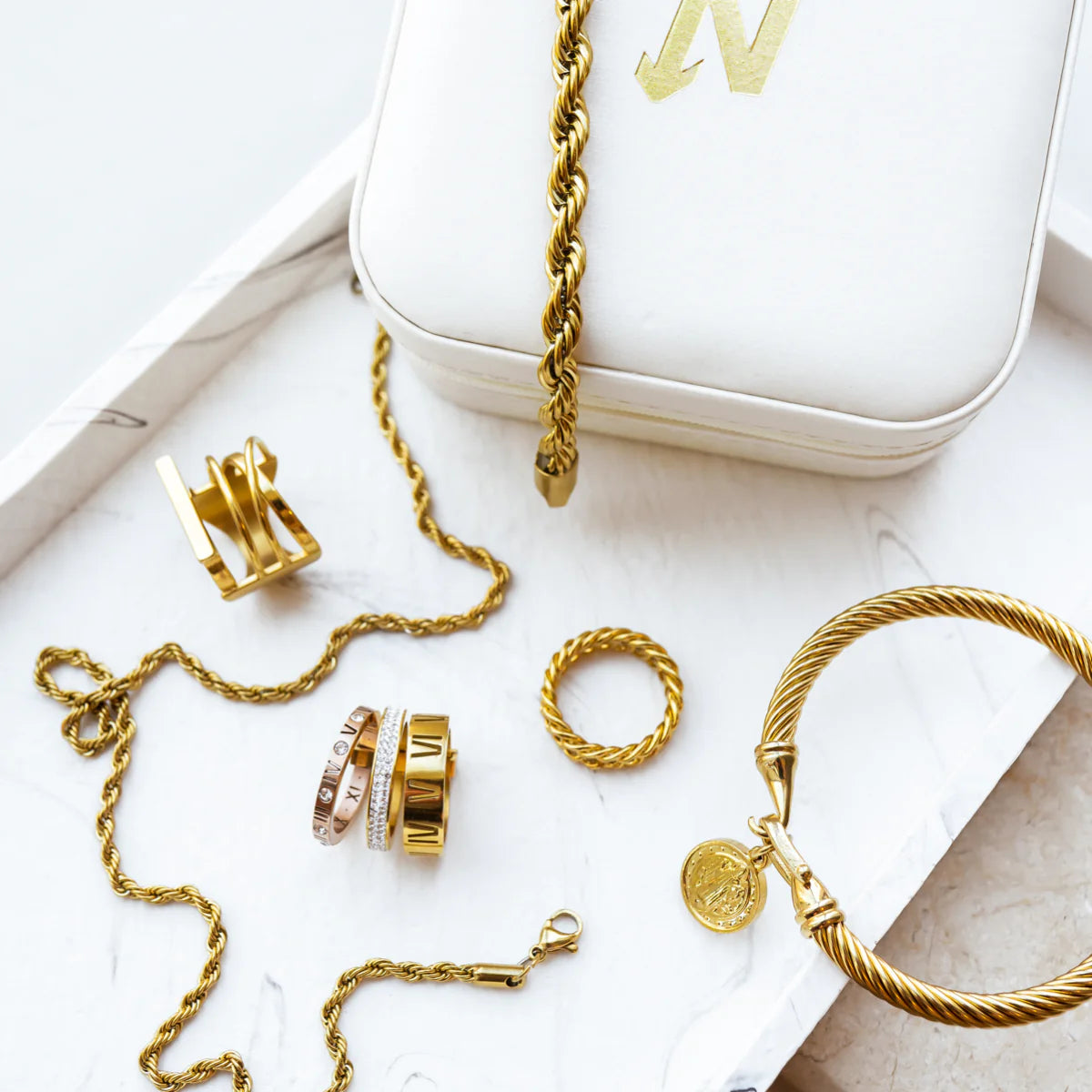 Gold Tone Rope Chain Bracelet displayed with matching gold jewelry pieces, highlighting its timeless design and versatility in accessory collections.