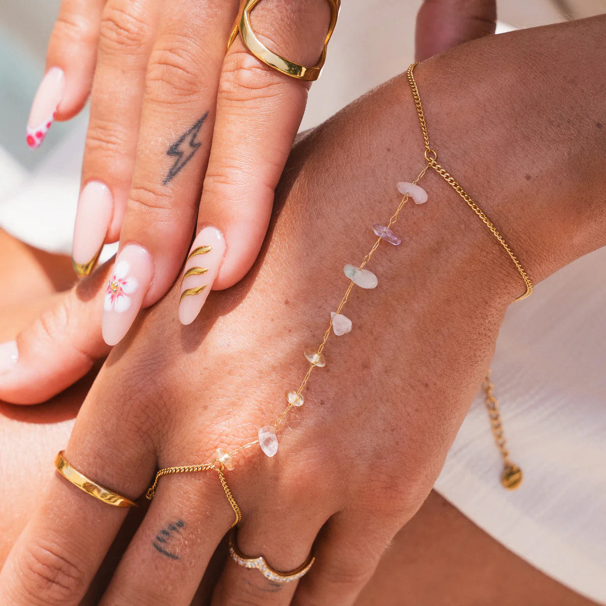 Gem Hand Chain - Gold Tone Tone Adjustable features delicate gemstones on a gold-finish chain connecting wrist to finger. Stylish waterproof jewelry for daily wear.